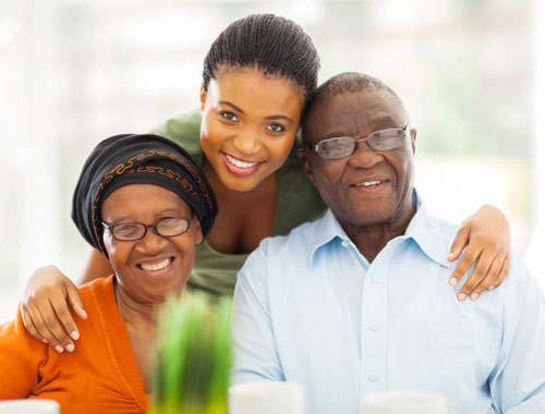 Daughter poses with her elderly parents