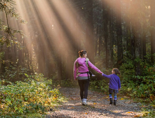 Mother and daughter hiking in the woods